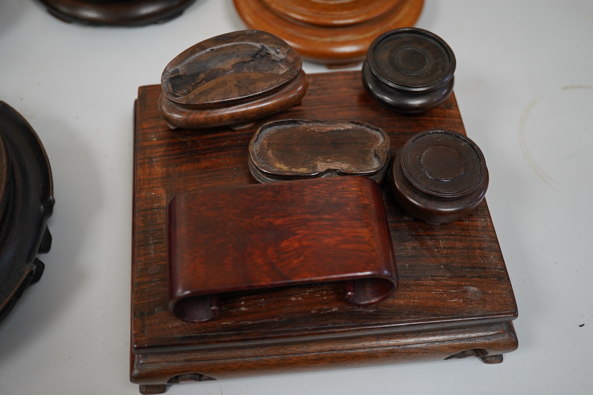 A group of 19th century and later Chinese hardwood stands, largest 18cm in diameter. Condition - mostly fair to good